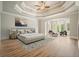 Inviting main bedroom with tray ceiling, wood floors, and sitting area bathed in natural light at 3689 Spring Hill Se Rd, Smyrna, GA 30080