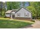 Charming home featuring gray siding, manicured lawn, and mature trees, offering a serene and inviting curb appeal at 3783 Ardsley Ct, Marietta, GA 30062
