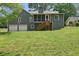 Back exterior view of two-story gray home, two car garage and screened in porch with stairway to backyard at 3783 Ardsley Ct, Marietta, GA 30062