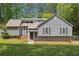 Charming home featuring gray siding, manicured lawn, and mature trees, offering a serene and inviting curb appeal at 3783 Ardsley Ct, Marietta, GA 30062