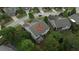 Aerial view of a well-maintained home with a deck surrounded by mature trees in a suburban neighborhood at 6614 Covered Bridge Way, Braselton, GA 30548