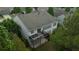 Aerial view of backyard with multi-level deck and surrounding landscape at 6614 Covered Bridge Way, Braselton, GA 30548
