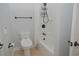 Clean bathroom featuring an updated toilet and shower with sleek fixtures and a shower curtain at 6614 Covered Bridge Way, Braselton, GA 30548