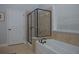 Modern bathroom featuring glass enclosed shower and soaking tub under window at 6614 Covered Bridge Way, Braselton, GA 30548