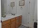 Bright bathroom features double sinks with framed mirror, modern fixtures, and updated finishes at 6614 Covered Bridge Way, Braselton, GA 30548