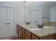 Bathroom with double vanity sinks, granite countertops, and modern fixtures at 6614 Covered Bridge Way, Braselton, GA 30548