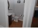 Half bathroom featuring hardwood floors, a modern toilet, and stylish vanity at 6614 Covered Bridge Way, Braselton, GA 30548
