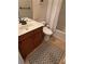 Cozy bathroom featuring wooden vanity, oval sink, toilet, tub, and shower at 6614 Covered Bridge Way, Braselton, GA 30548