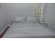 A view of the bedroom featuring a luxurious bed and a bright window at 6614 Covered Bridge Way, Braselton, GA 30548
