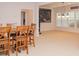Bright dining area with a cozy table, decorative lighting, and carpeted flooring at 6614 Covered Bridge Way, Braselton, GA 30548