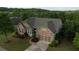 Beautiful, brick home features a well-manicured lawn, professional landscaping, and two car garage at 6614 Covered Bridge Way, Braselton, GA 30548