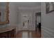 Inviting foyer with hardwood floors, ornate mirror, stained glass front door, and elegant trim at 6614 Covered Bridge Way, Braselton, GA 30548