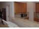 Charming kitchen boasts granite countertops, wooden cabinets, and modern appliances at 6614 Covered Bridge Way, Braselton, GA 30548