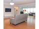 Open-concept living room featuring hardwood floors, natural light, and stylish decor at 6614 Covered Bridge Way, Braselton, GA 30548