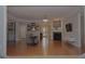 Open living room features wood floors, fireplace, and multiple windows for great lighting at 6614 Covered Bridge Way, Braselton, GA 30548