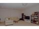 The living room features a beige sofa, a small table, and wooden bookshelves at 6614 Covered Bridge Way, Braselton, GA 30548