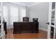 Elegant home office featuring a beautiful desk, hardwood floors, and ample natural light at 6614 Covered Bridge Way, Braselton, GA 30548