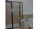 Bathroom with a walk-in shower featuring a glass door and tan tile at 6614 Covered Bridge Way, Braselton, GA 30548
