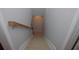Carpeted staircase with wooden handrail and white trim leading to the next level of the home at 6614 Covered Bridge Way, Braselton, GA 30548