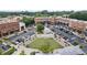 Aerial view showcasing a vibrant town square, mixed-use buildings, central lawn and convenient parking at 7235 Cordery Rd, Cumming, GA 30040
