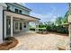 Charming backyard with brick patio, featuring an outdoor ceiling fan and lush greenery at 7235 Cordery Rd, Cumming, GA 30040