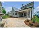 View of the backyard with brick patio, outdoor ceiling fan and manicured lawn at 7235 Cordery Rd, Cumming, GA 30040