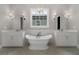 Bright bathroom with a soaking tub, dual vanities, and stylish lighting at 7235 Cordery Rd, Cumming, GA 30040