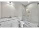 Modern bathroom features gray tiled floors, glass shower and white vanity with stone countertop at 7235 Cordery Rd, Cumming, GA 30040