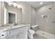 Bathroom boasting modern fixtures, a tiled shower with bench, and white vanity with stone countertops at 7235 Cordery Rd, Cumming, GA 30040