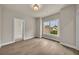 Bedroom with hardwood floors, large window, and neutral colors at 7235 Cordery Rd, Cumming, GA 30040