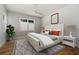 Neutral bedroom with a large window, ceiling fan, and stylish decor at 7235 Cordery Rd, Cumming, GA 30040