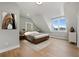 Bedroom featuring modern furniture, hardwood floors, and a window with a view at 7235 Cordery Rd, Cumming, GA 30040