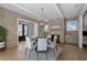 Elegant dining room with brick accent walls, a modern chandelier, and seating for six at 7235 Cordery Rd, Cumming, GA 30040