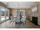 Stylish dining room featuring brick accent walls, modern decor and open to other spaces at 7235 Cordery Rd, Cumming, GA 30040