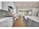 Stylish kitchen with white cabinetry, stainless steel appliances, tile backsplash and a view to the living area at 7235 Cordery Rd, Cumming, GA 30040