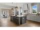 Bright kitchen featuring an island with seating, stainless appliances, light countertops, and wood floors at 7235 Cordery Rd, Cumming, GA 30040