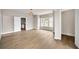 Open-concept living room boasting hardwood floors and a large window that lets in plenty of natural light at 7235 Cordery Rd, Cumming, GA 30040