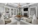 Comfortable living room with white sofas, a modern fireplace, exposed beams, and French doors at 7235 Cordery Rd, Cumming, GA 30040