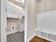Mudroom with patterned floors, white storage cabinets and mud bench at 7235 Cordery Rd, Cumming, GA 30040