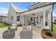 Inviting covered patio with comfortable seating and a brick paved floor perfect for outdoor entertaining at 7235 Cordery Rd, Cumming, GA 30040
