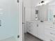 Bright bathroom with glass enclosed shower, white cabinets, and tile floors at 7275 Cordery Rd, Cumming, GA 30040