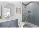 Bright bathroom with glass shower, vanity, and tile floors at 7275 Cordery Rd, Cumming, GA 30040