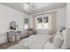 Comfortable bedroom with white walls, ceiling fan, and natural light at 7275 Cordery Rd, Cumming, GA 30040