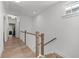 Upstairs hallway with hardwood floors and railing at 7275 Cordery Rd, Cumming, GA 30040