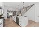 Beautiful open-concept kitchen with white cabinets, marble countertops, and stainless steel appliances with access to living area at 7275 Cordery Rd, Cumming, GA 30040