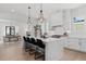 Modern kitchen featuring an island with marble countertops, stainless steel appliances, and open-concept design to other living areas at 7275 Cordery Rd, Cumming, GA 30040
