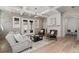 Cozy living room with brick walls, fireplace, wood floors, comfortable seating, and plenty of natural light at 7275 Cordery Rd, Cumming, GA 30040