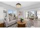 Bright living room with large windows, neutral decor, wood floors, and comfortable seating, perfect for entertaining at 7275 Cordery Rd, Cumming, GA 30040