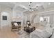 Open living space with fireplace, light wood floors, and view of kitchen at 7275 Cordery Rd, Cumming, GA 30040
