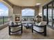 Expansive covered balcony featuring a fireplace, grill, and comfortable seating with scenic views at 88 W Paces Ferry # 2230, Atlanta, GA 30305